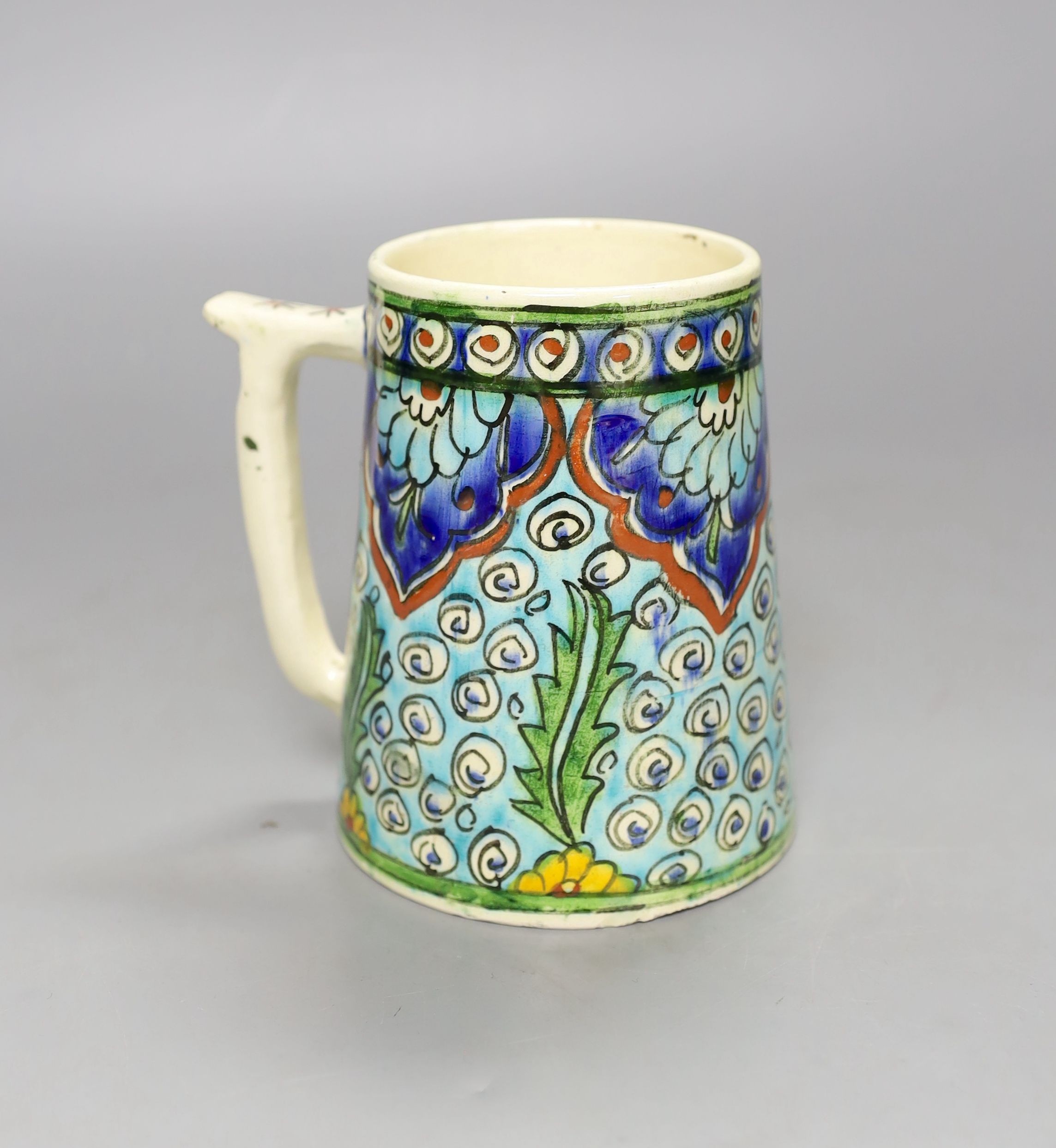 A Turkish Kutahya earthenware tapering mug, 12.5 cm high
